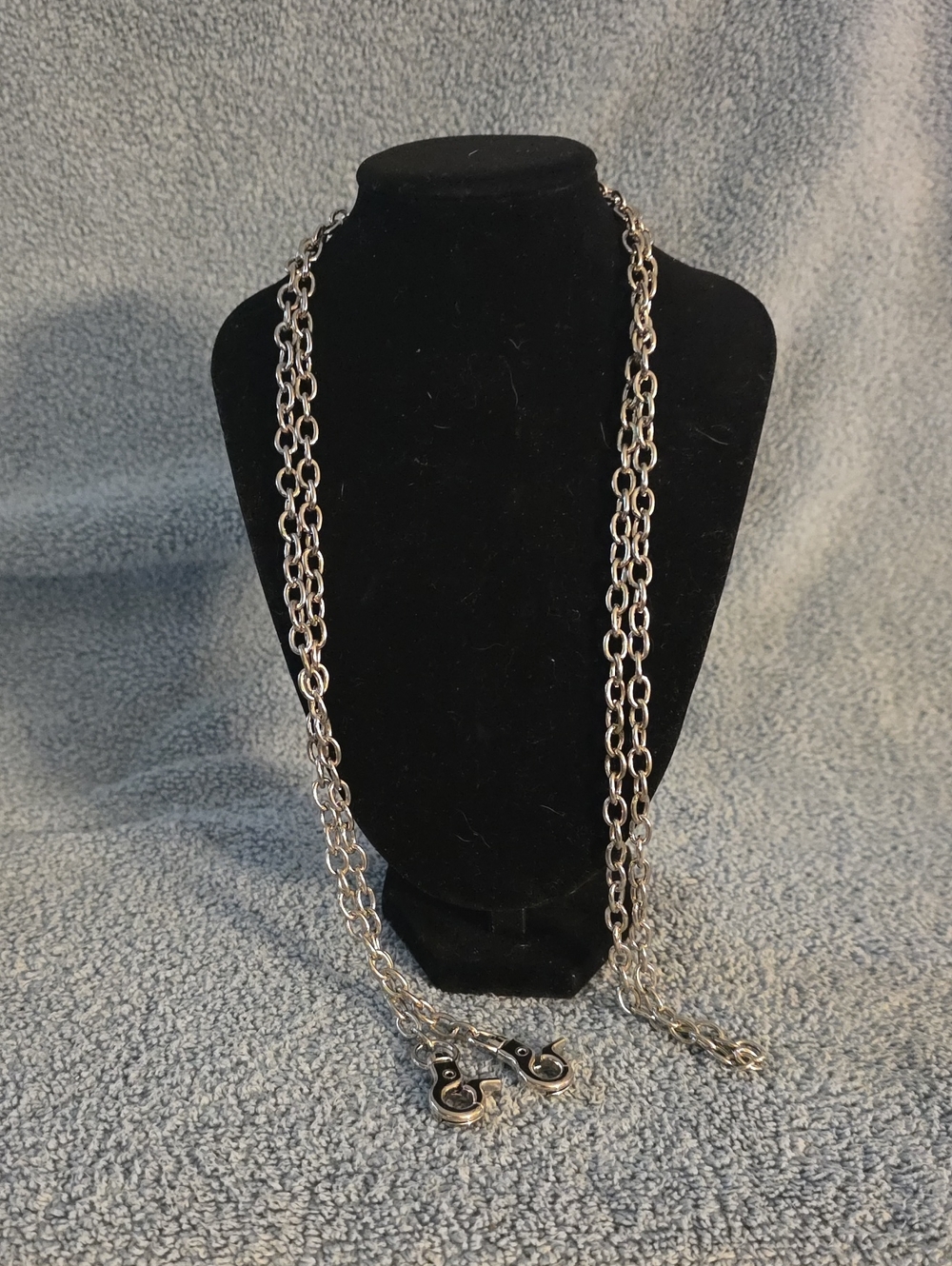 silver-tone chain necklace featuring spring-loaded swivel clasp hooks